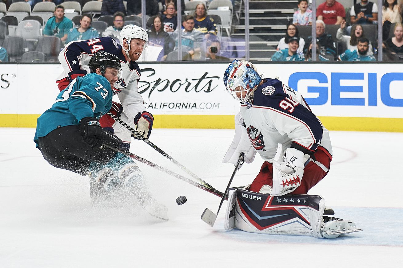 Columbus Blue Jackets goaltender Elvis Merzlikins (90) makes a save on San Jose Sharks center Noah Gregor (73) during the NHL game between the San Jose Sharks and the Columbus Blue Jackets on April 19, 2022 at SAP Center in San Jose, CA.