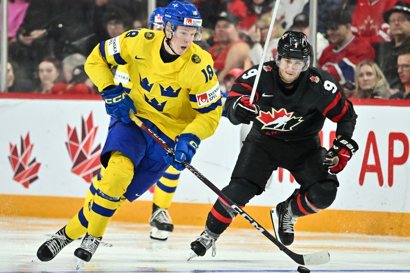 Filip Bystedt #18 of Team Sweden skates the puck against Joshua Roy #9 of Team Canada during the third period in the 2023 IIHF World Junior Championship at Scotiabank Centre on December 31, 2022 in Halifax, Nova Scotia, Canada. Team Canada defeated Team Sweden 5-1.