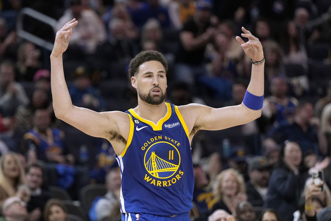 Klay Thompson raising his hands in celebration