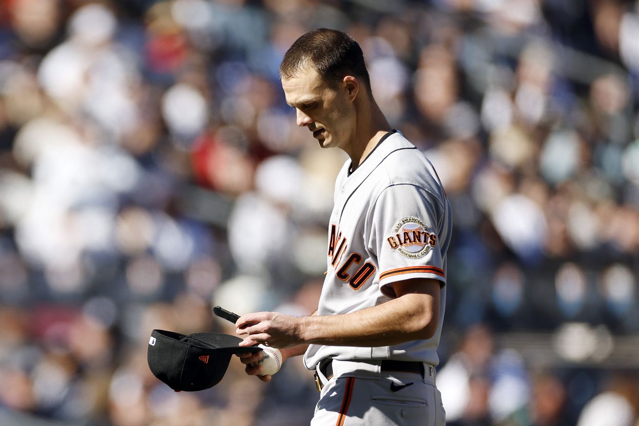 Tyler Rogers looking at his hat 