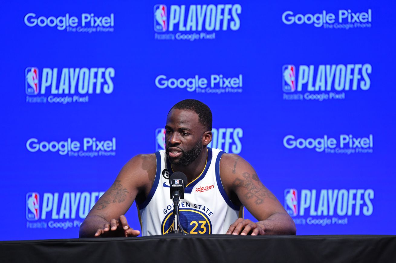 Draymond Green answering questions at the press conference table