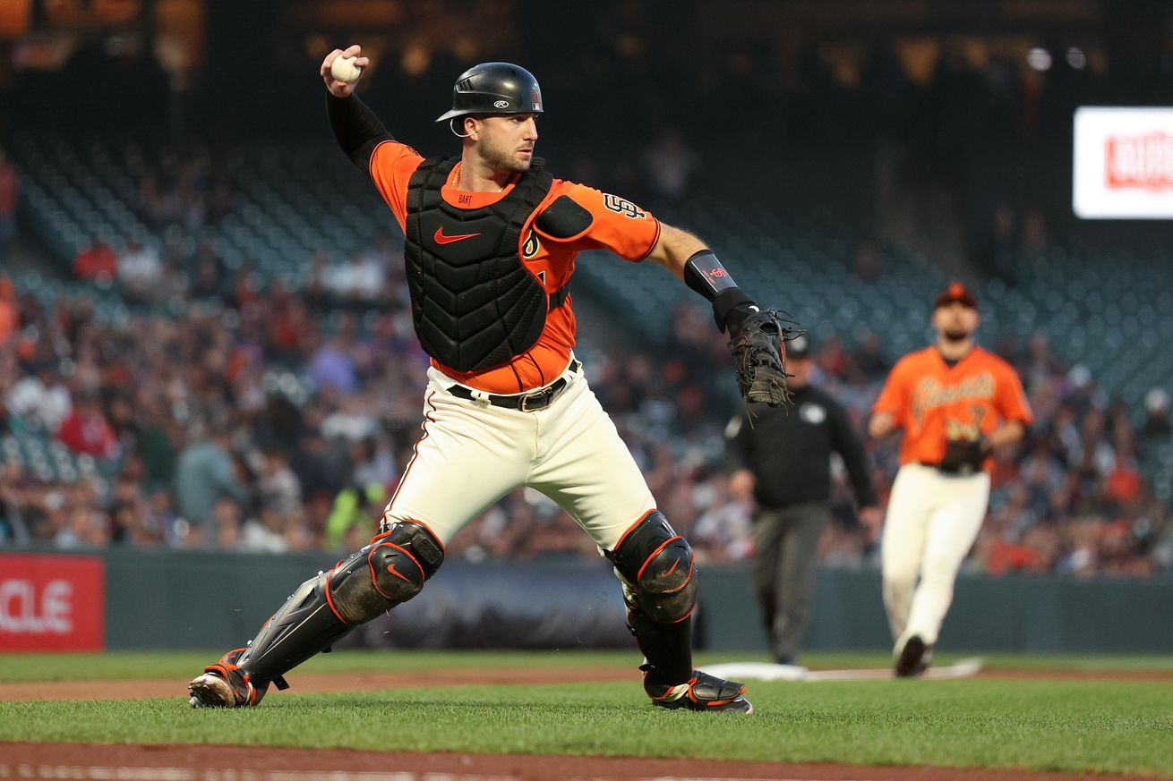 Joey Bart making a throw in his catcher’s gear