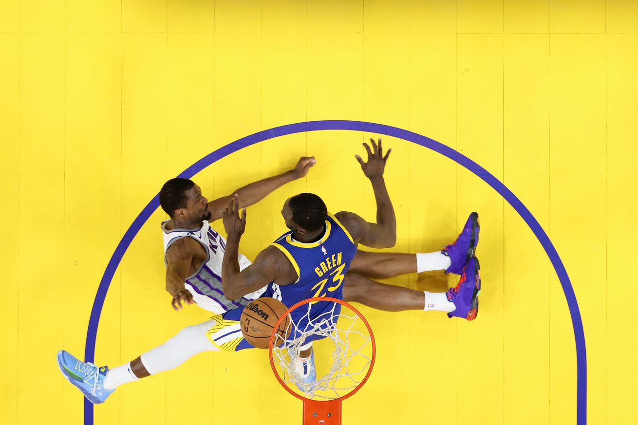 Overhead view of Draymond Green colliding with Harrison Barnes while trying to block a shot at the rim. 