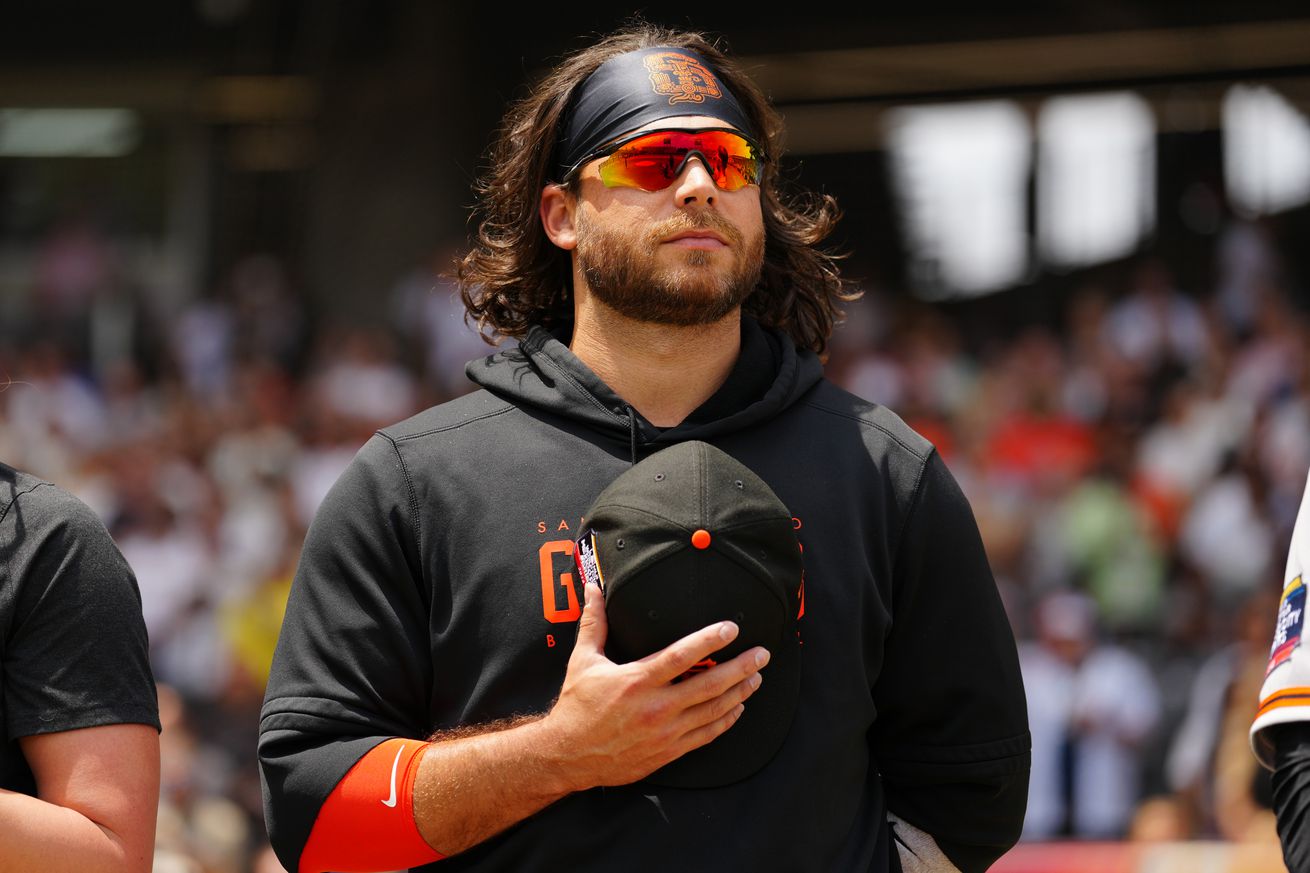 Brandon Crawford standing with his hat over his chest