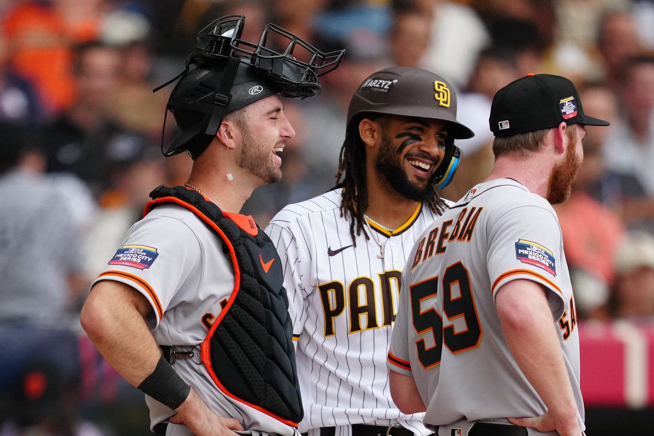 Joey Bart, John Brebbia, and Fernando Tatis Jr. laughing on the field