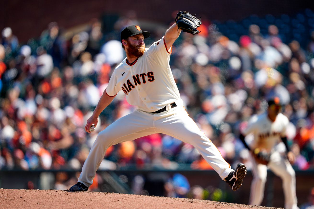 John Brebbia reaching back to throw a pitch