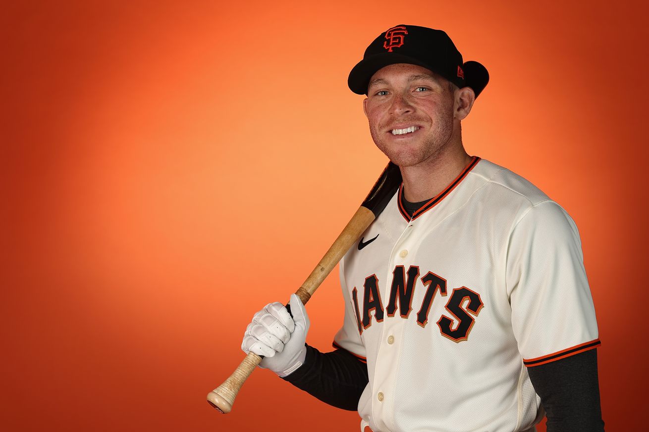 Vaun Brown posing with a bat on his shoulder at media day