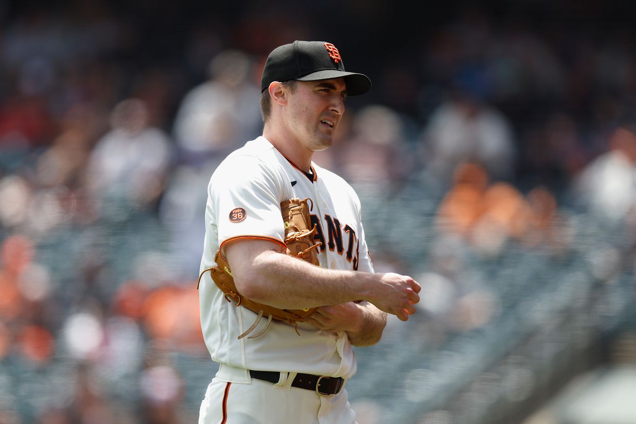 Ross Stripling rubbing up a baseball on the mound