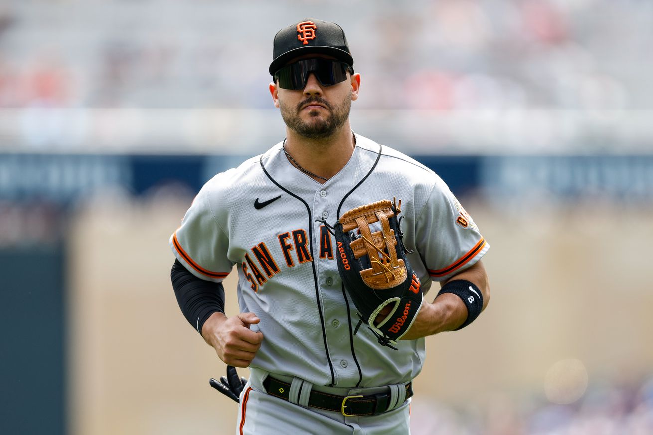 Michael Conforto jogging off the field, wearing his glove