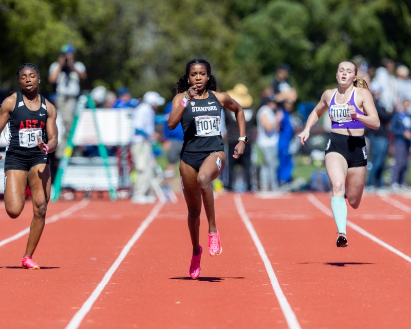 Three sprinters run along the track during a race