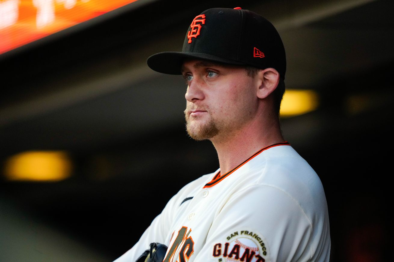 Keaton Winn standing in the dugout