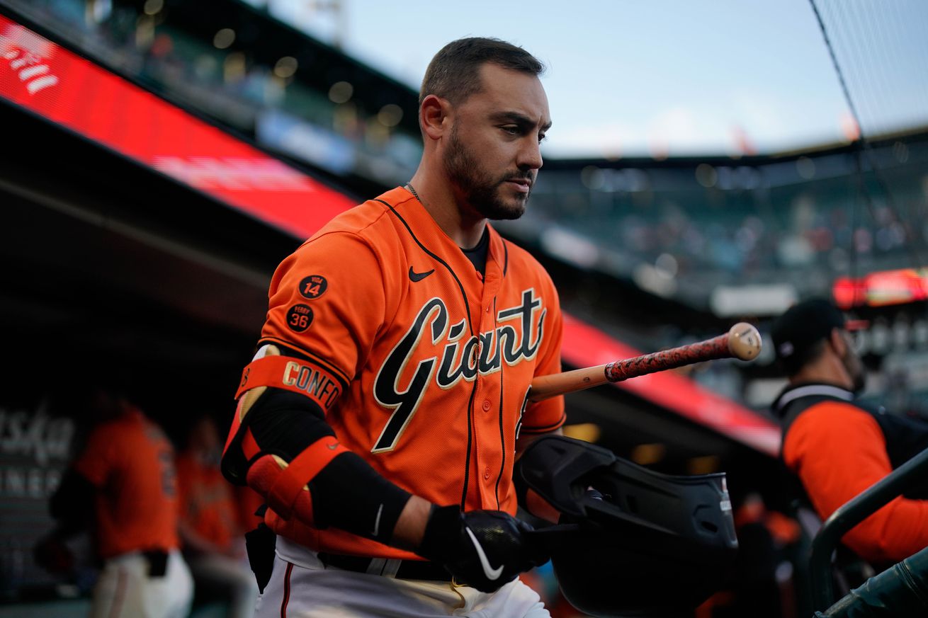 Michael Conforto walking with a bat tucked under his arm