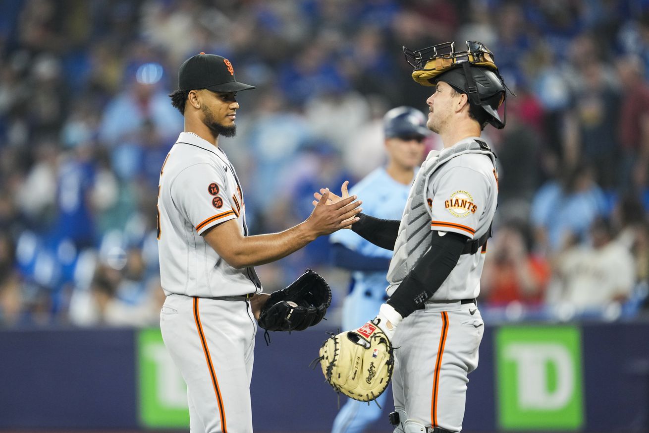 Patrick Bailey and Camilo Doval shaking hands after a game