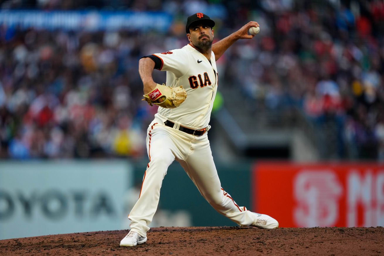 Scott Alexander reaching back to throw a pitch 