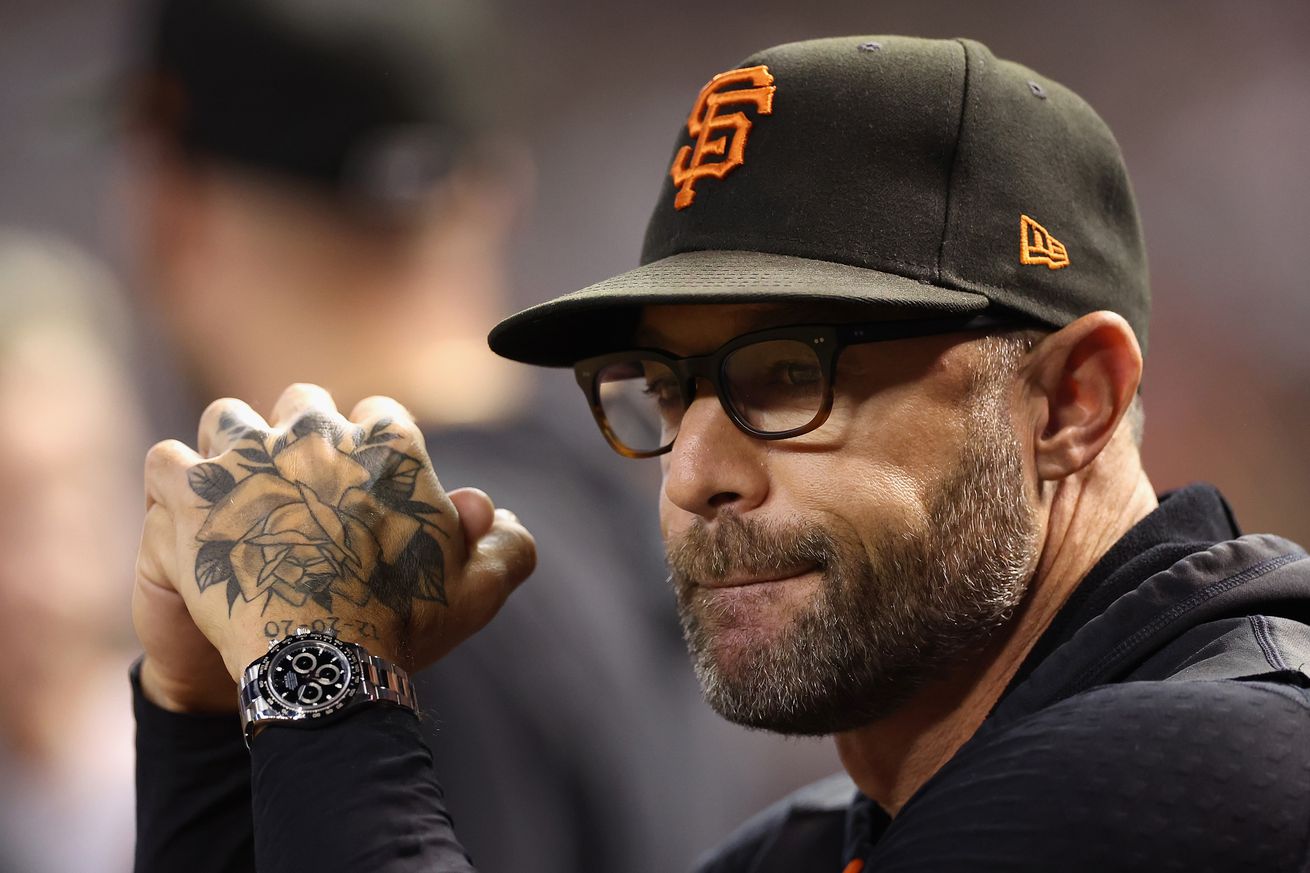 Gabe Kapler sitting in the dugout with his hands near his face