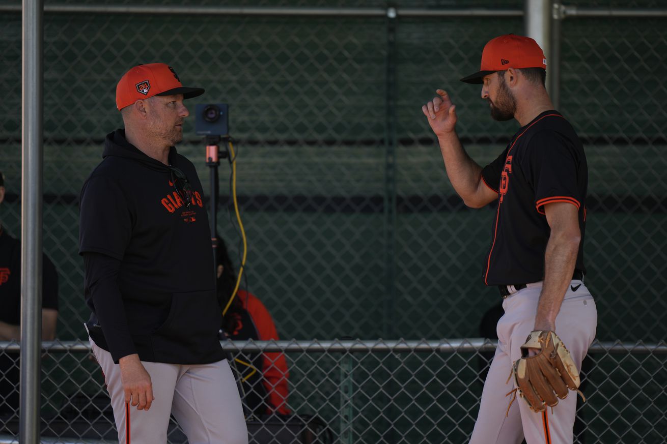 Tristan Beck talking to J.P. Martinez in the bullpen. 