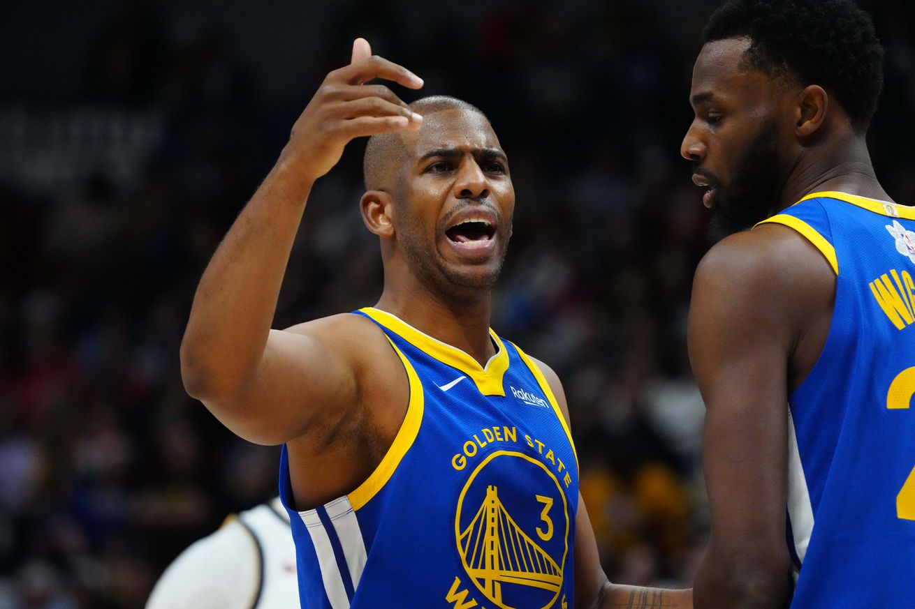 Chris Paul yelling and motioning to someone while Andrew Wiggins stands next to him.