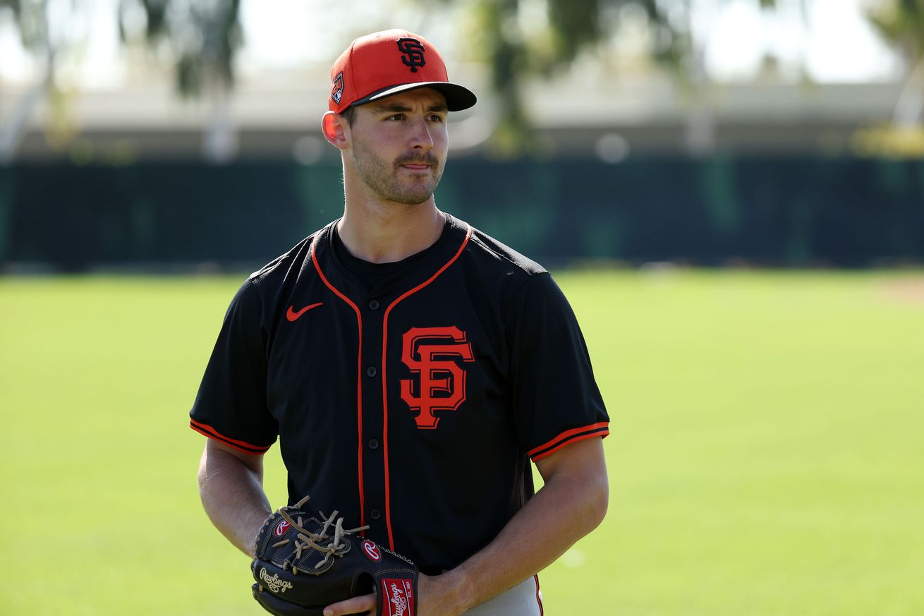 Mason Black standing on a baseball field, with his hand in his glove. 