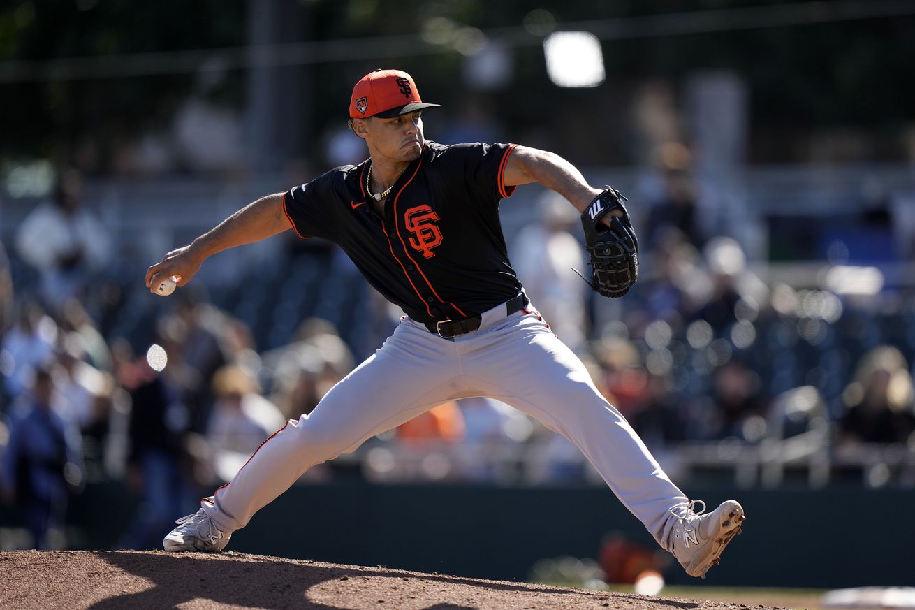 Side view of Jordan Hicks reaching back to throw a pitch. 