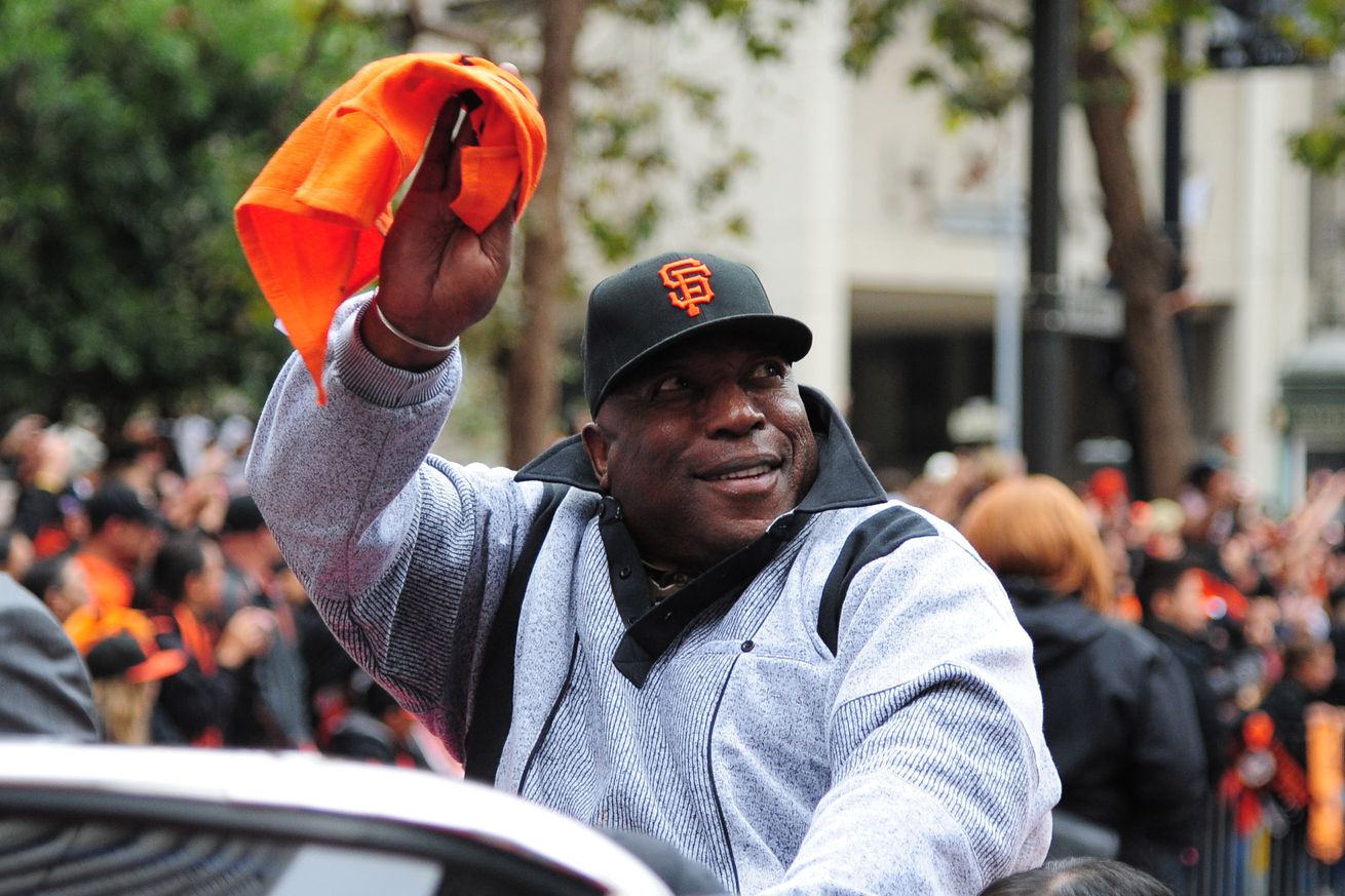 Willie McCovey in a convertible, waving a Giants flag at the 2012 World Series parade. 