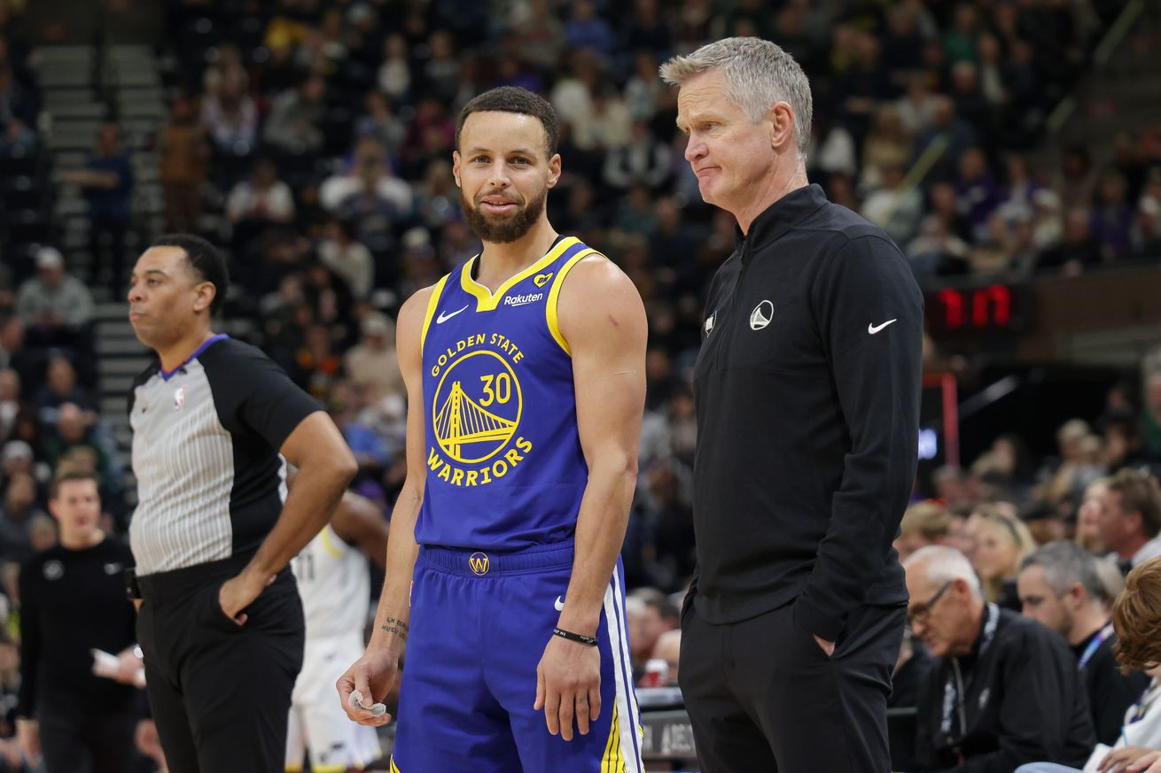 Steph Curry standing next to Steve Kerr.  