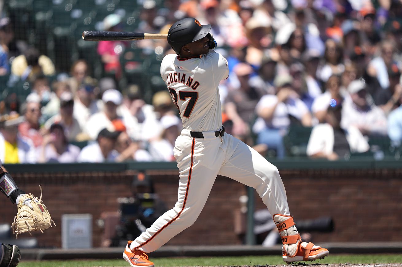 Marco Luciano swinging a bat. 