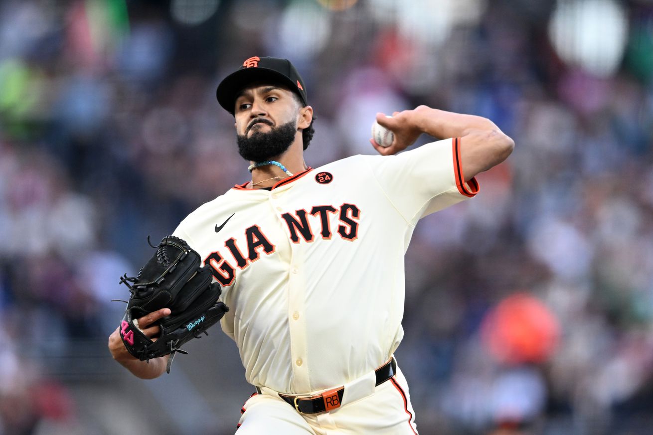 Raymond Burgos reaching back to throw a pitch. 