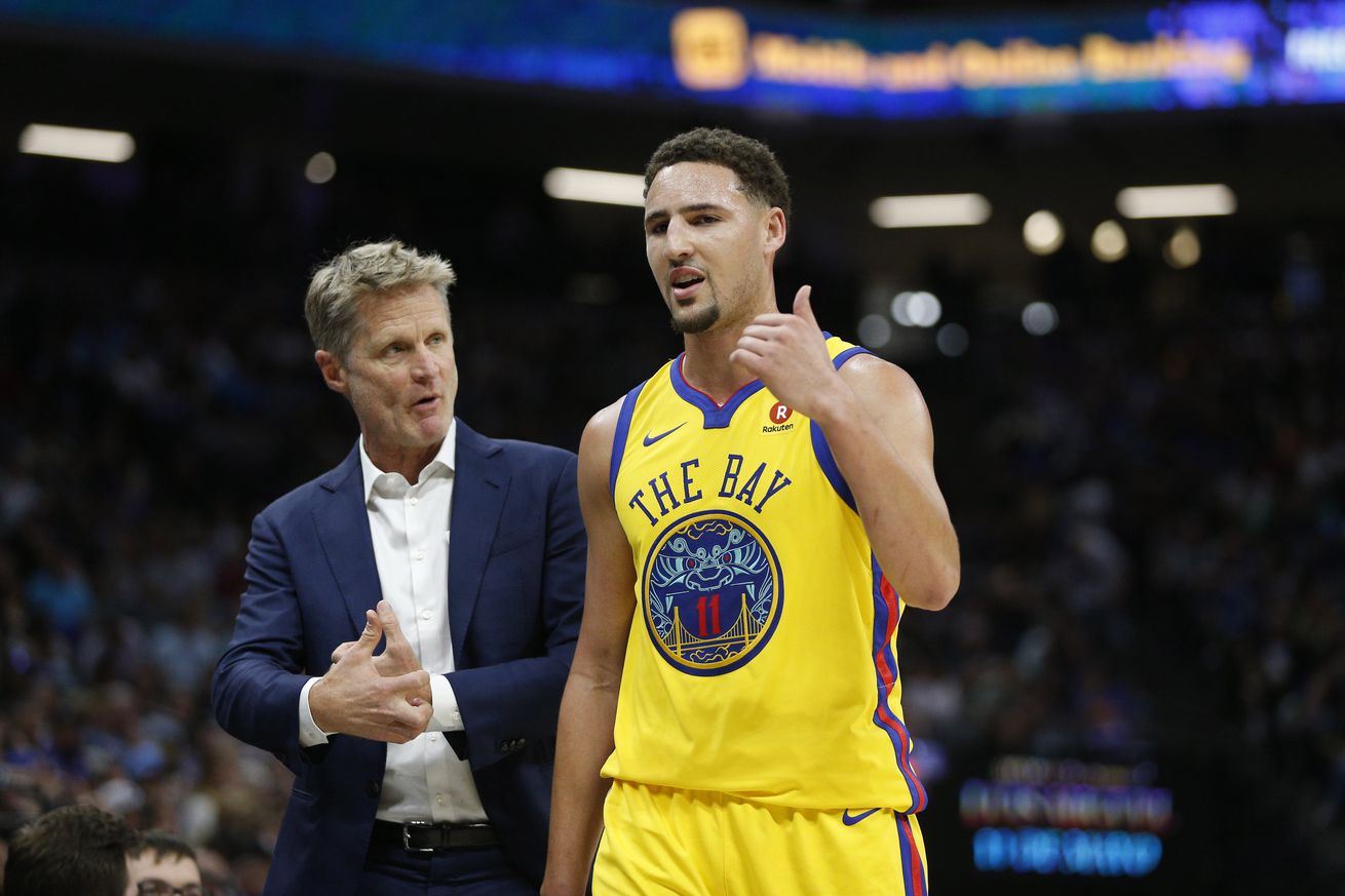 Klay Thompson standing next to Steve Kerr. 