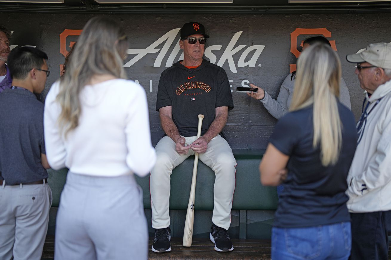 Bob Melvin sitting in the clubhouse, talking to reporters. 