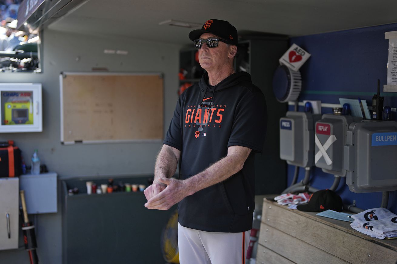 Bob Melvin standing in the Giants dugout. 