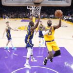 Apr 9, 2024; Los Angeles, California, USA; Los Angeles Lakers forward LeBron James (23) shoots the ball against Golden State Warriors forward Draymond Green (23) in the second half at Crypto.com Arena. Mandatory Credit: Kirby Lee-USA TODAY Sports