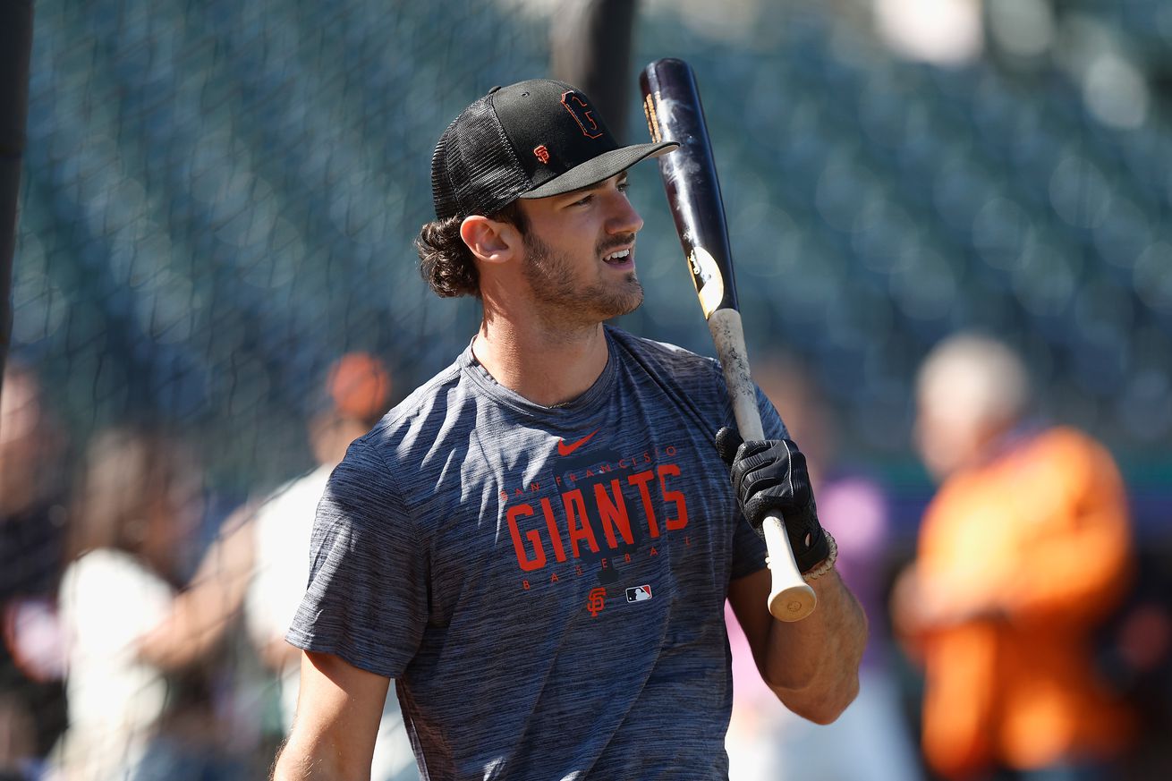 Bryce Eldridge holding a bat and looking into the distance in the batting cage. 