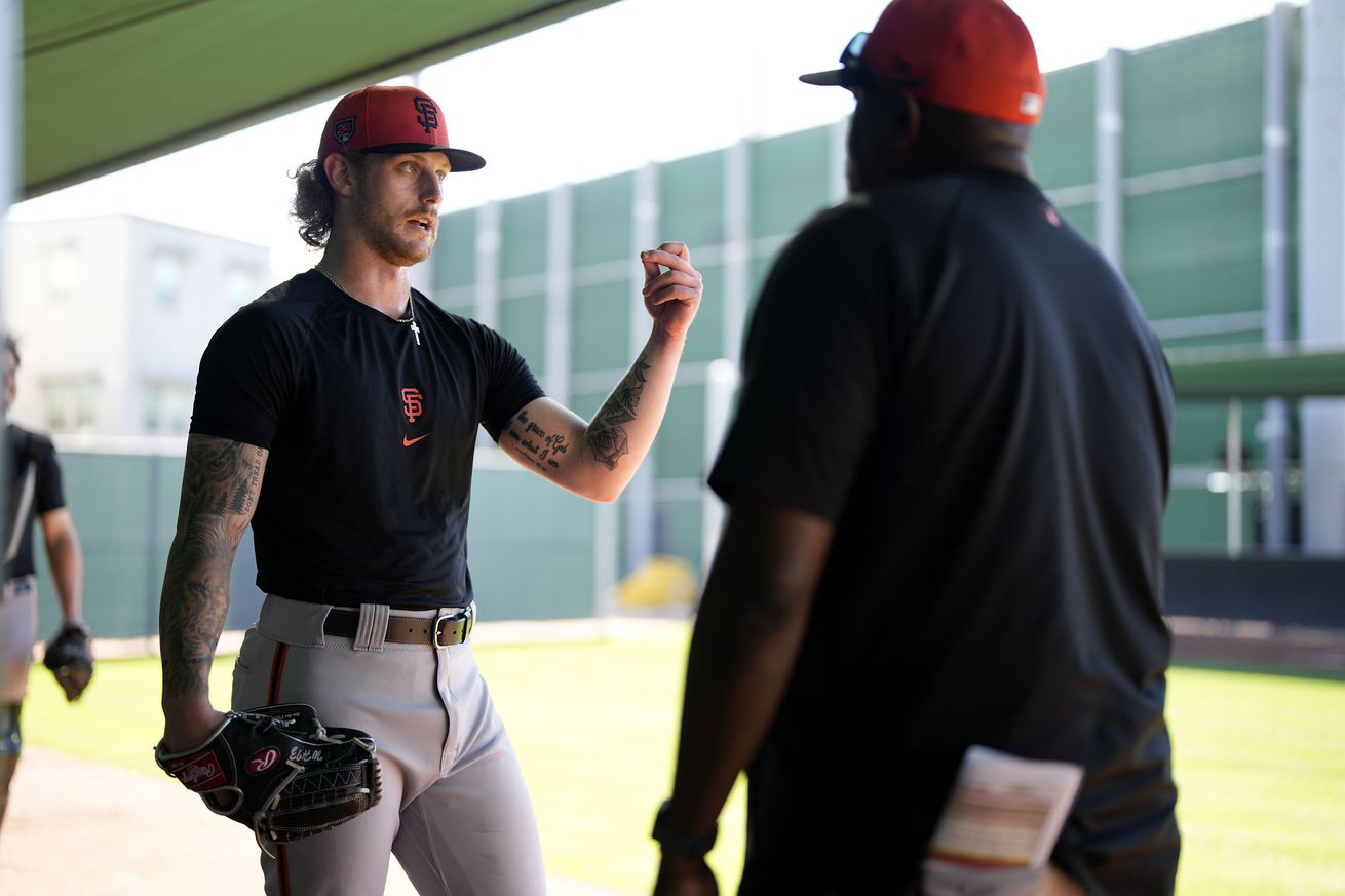 Carson Whisenhunt talking with a coach during a bullpen session. 