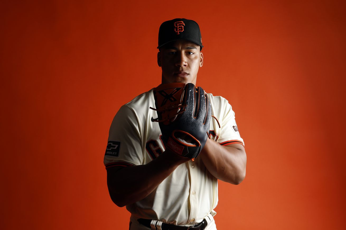 Reggie Crawford posing with his mitt at media day. 