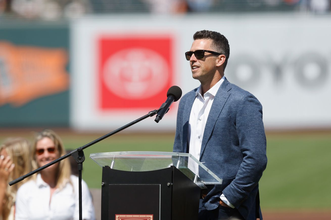 Buster Posey speaking at a podium. 