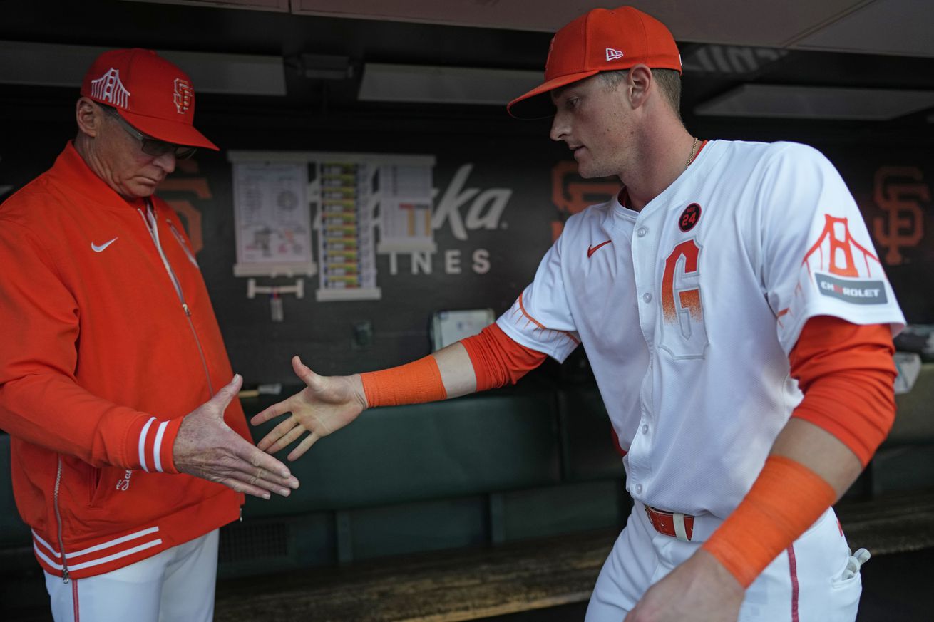 Tyler Fitzgerald reaching out to shake Bob Melvin’s hand. 