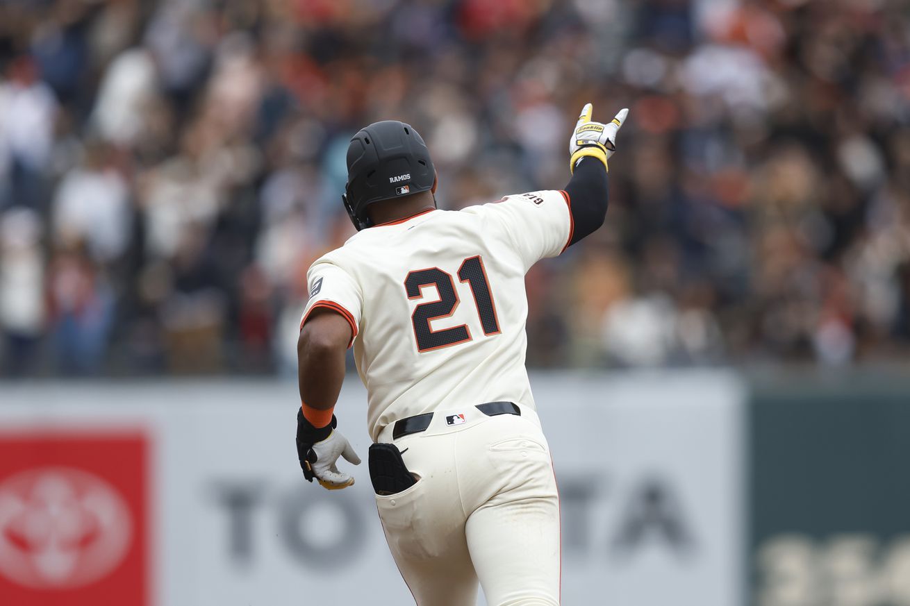 View from behind of Heliot Ramos rounding the bases. 