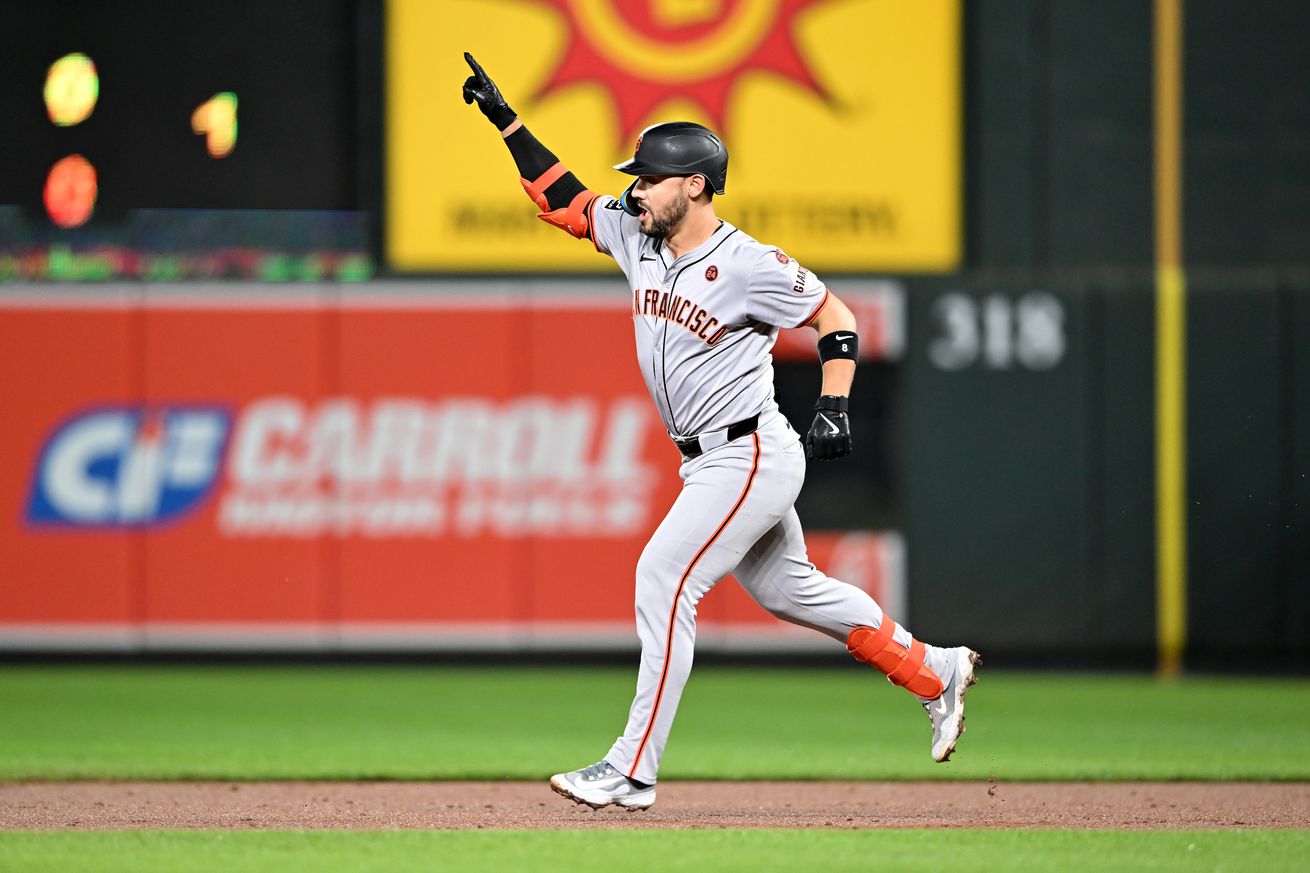 Michael Conforto raising his arm as he runs the basepaths after a home run. 