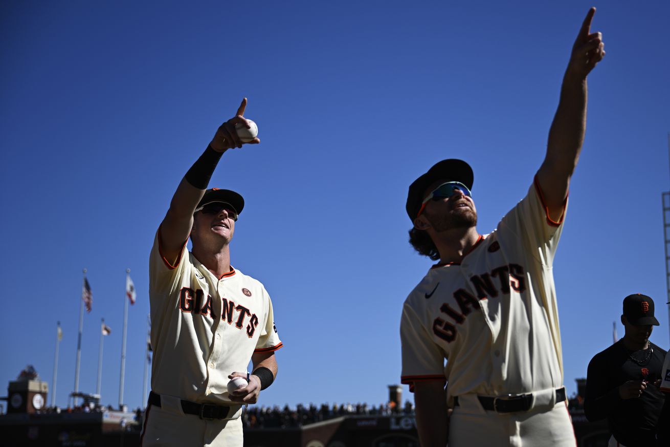 Tyler Fitzgerald and Brett Wisely pointing to the stands after the season finale. 