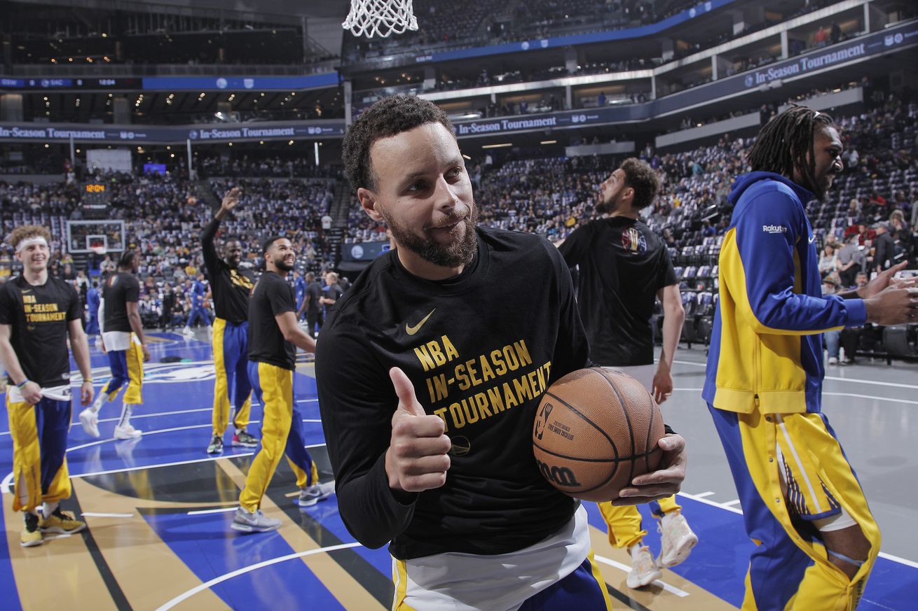 Steph Curry in warmups, giving a thumbs up. 