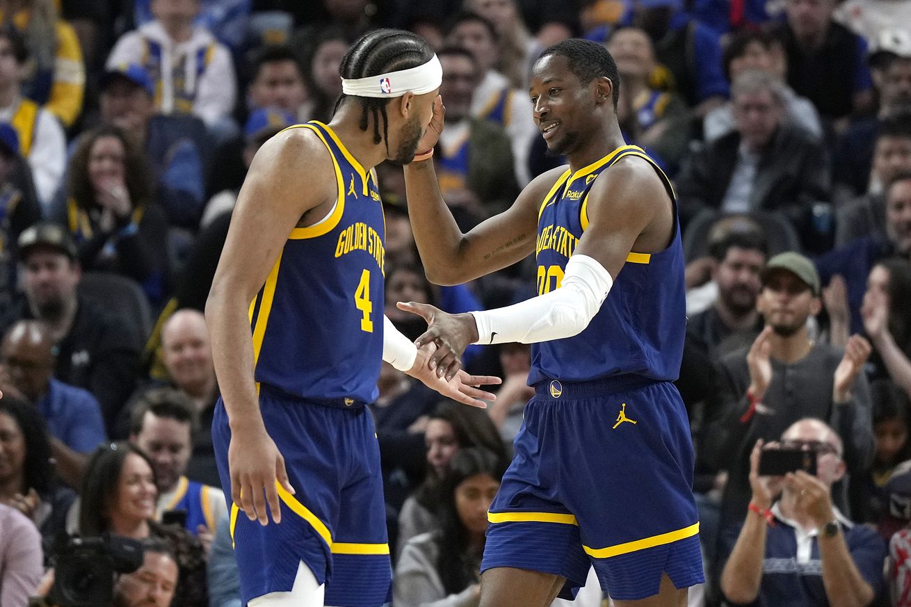 Moses Moody and Jonathan Kuminga celebrating as they run down the court