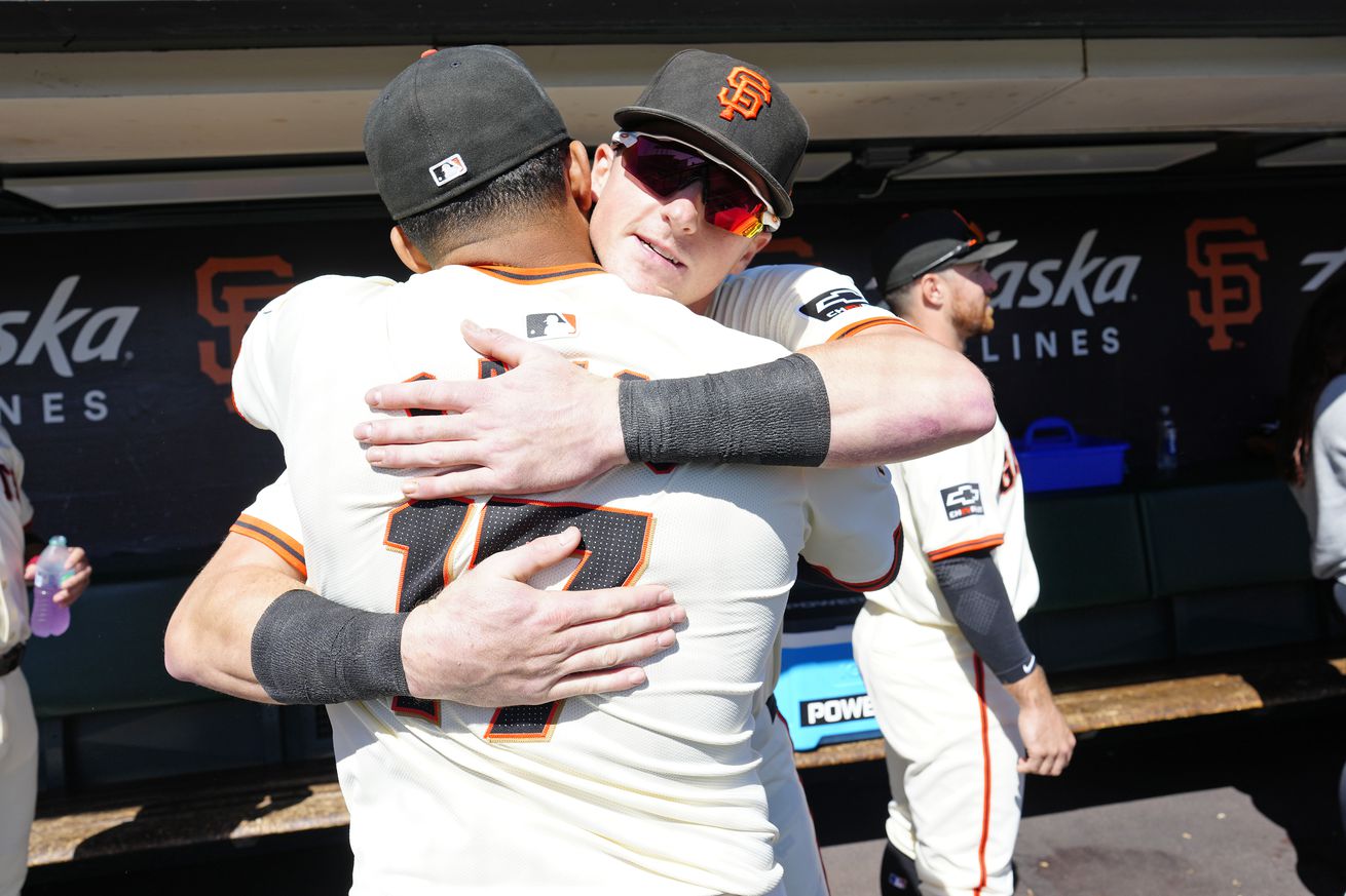 Heliot Ramos hugging Tyler Fitzgerald. 