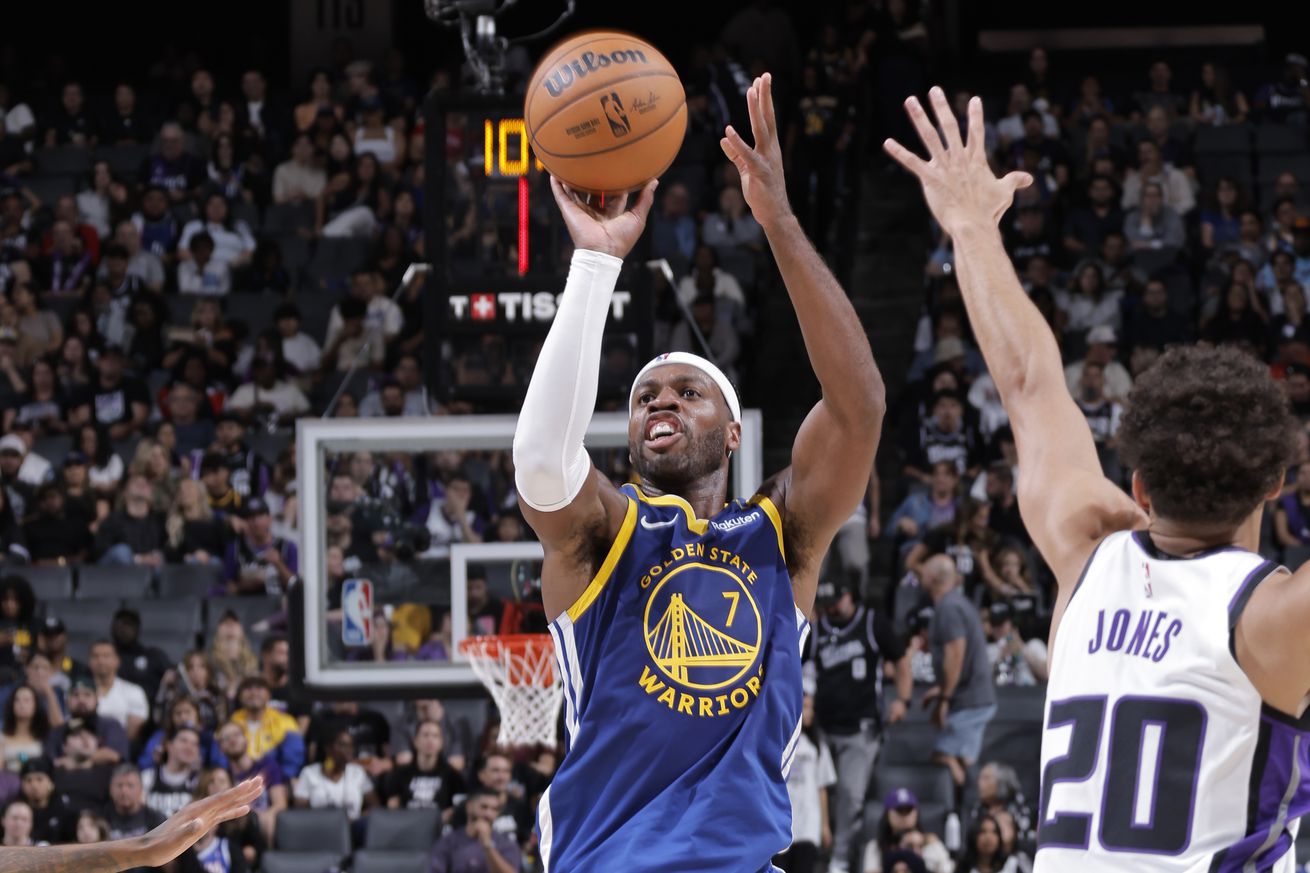 Buddy Hield shooting a jumper over the outstretched arm of a Kings defender. 