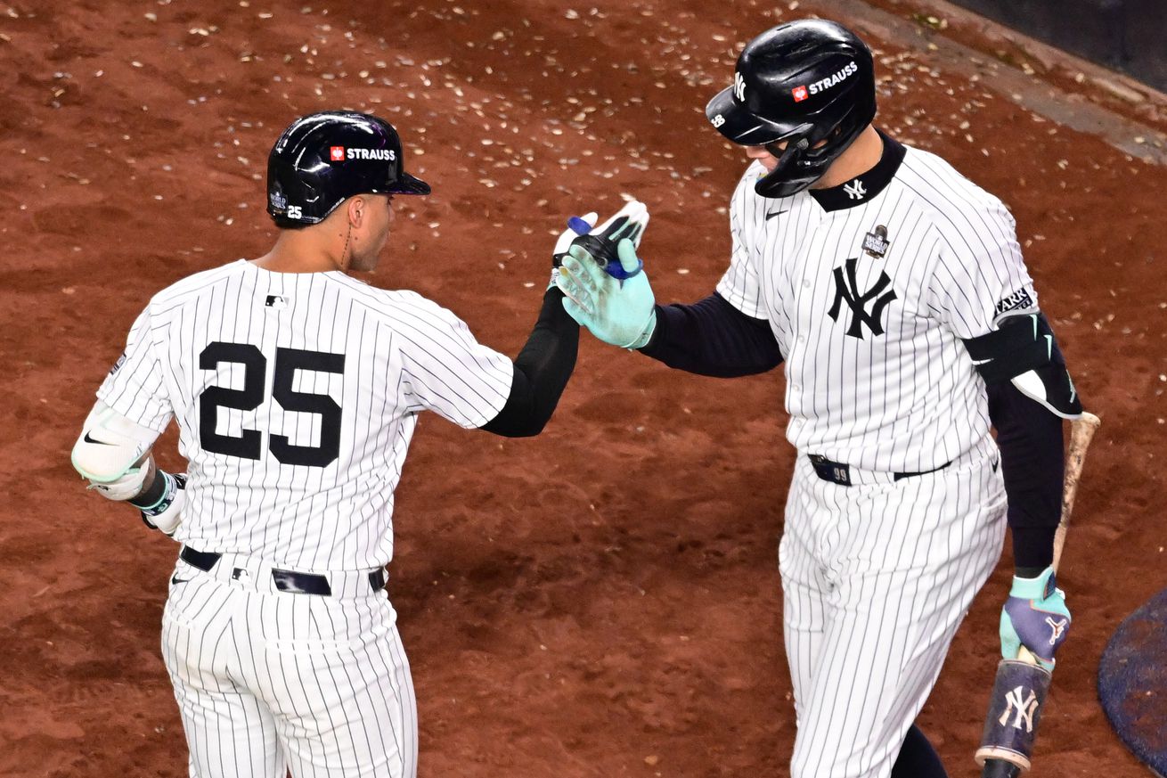 Gleyber Torres and Aaron Judge high-fiving. 