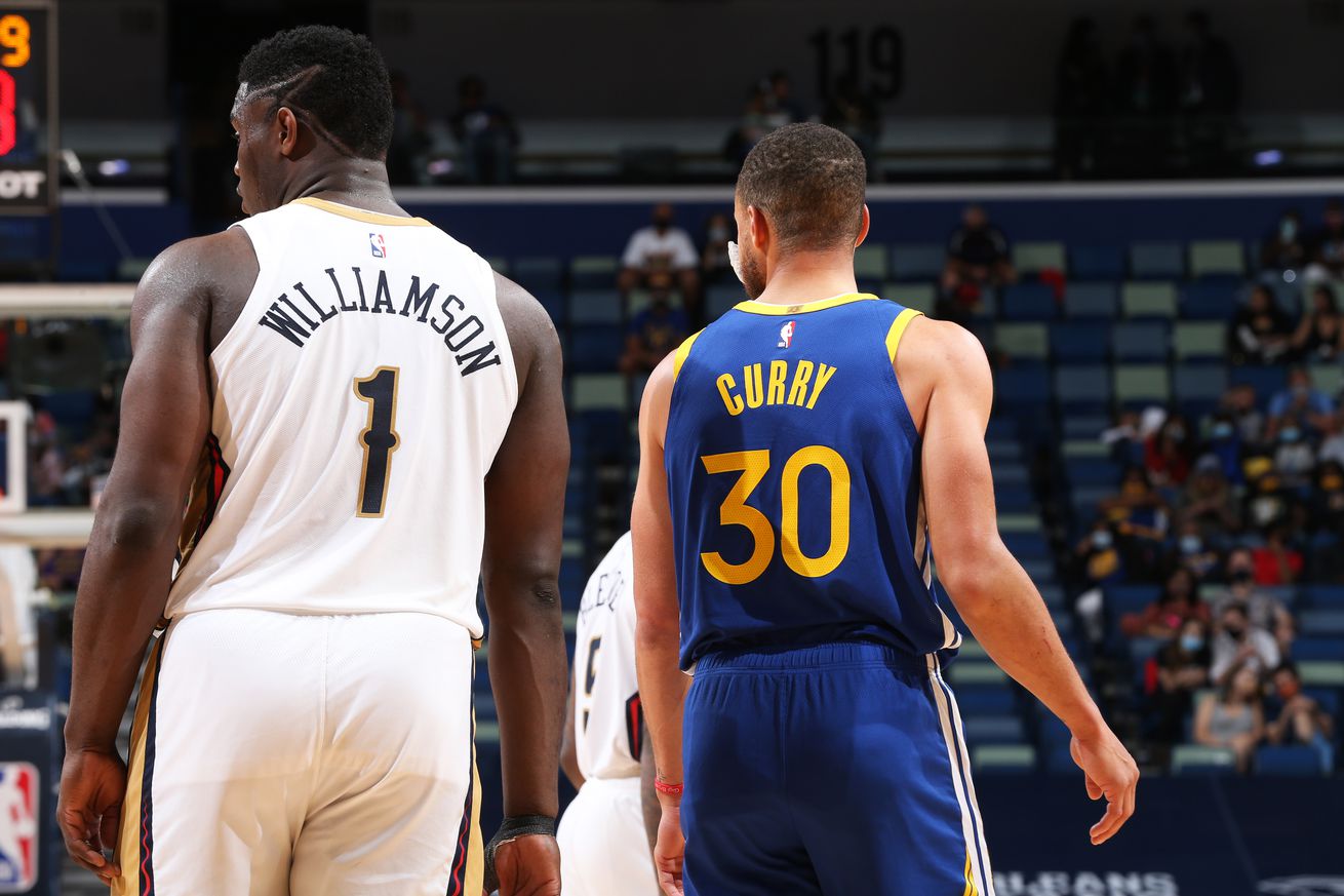 View from behind of Steph Curry standing next to Zion Williamson.