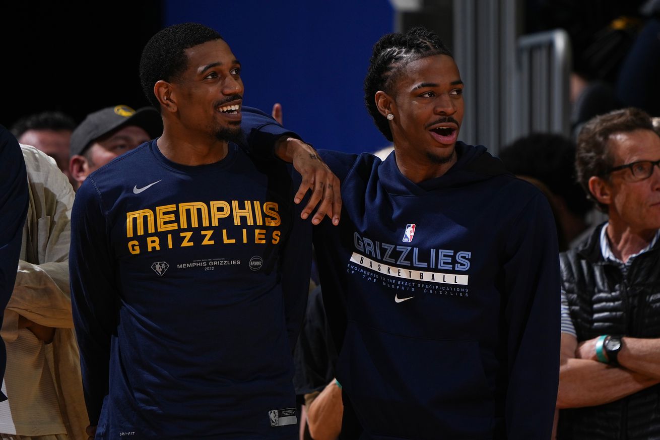 Ja Morant and De’Anthony Melton standing next to each other in Grizzlies warmup jerseys.