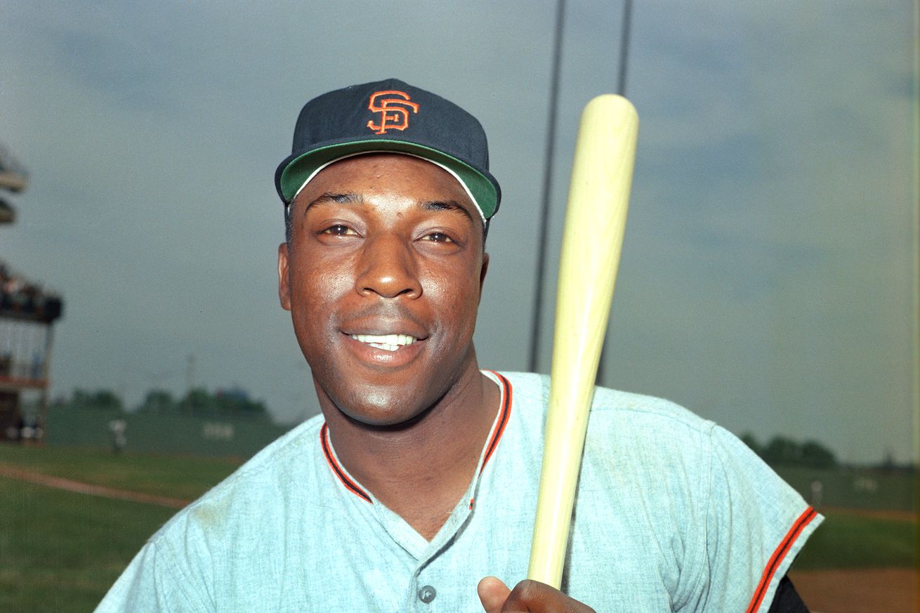 Close up of Willie McCovey posing with a bat on his shoulder. 