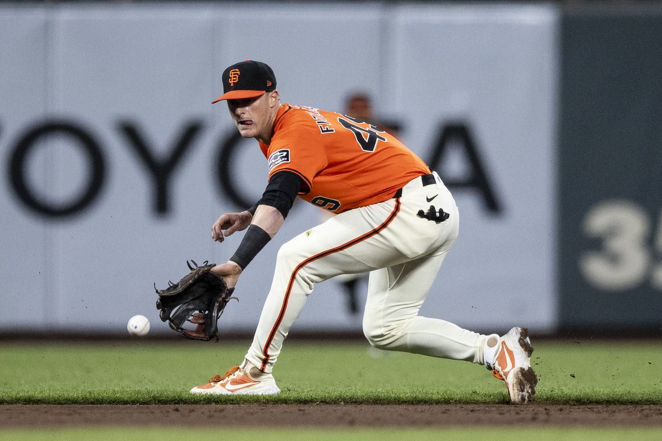 Tyler Fitzgerald reaching for a backhand groundball. 