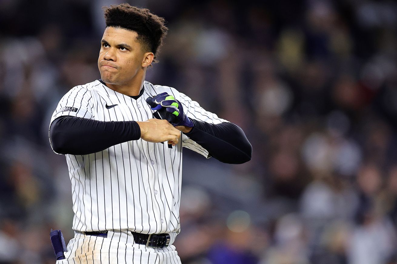 Juan Soto angrily taking his batting gloves off.