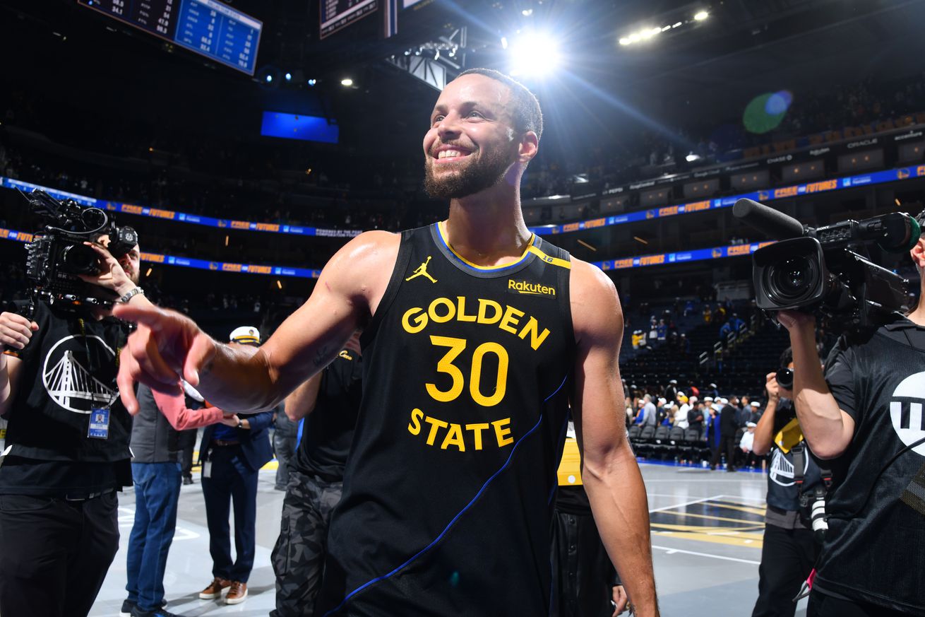 Steph Curry smiling after a game. 